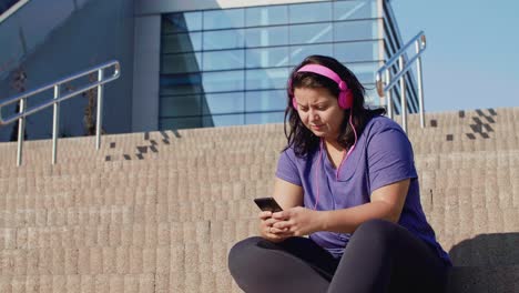 woman using mobile phone after hard workout