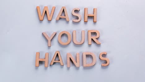 word wash your hands made of dancing letters on a white background.