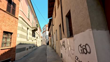 a narrow alley with graffiti-covered walls