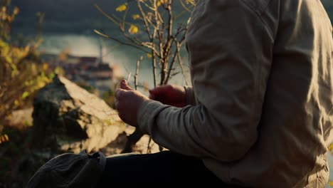 hiker rest time, rolling his cigarette, relaxing in peaceful calm nature, vogelberg