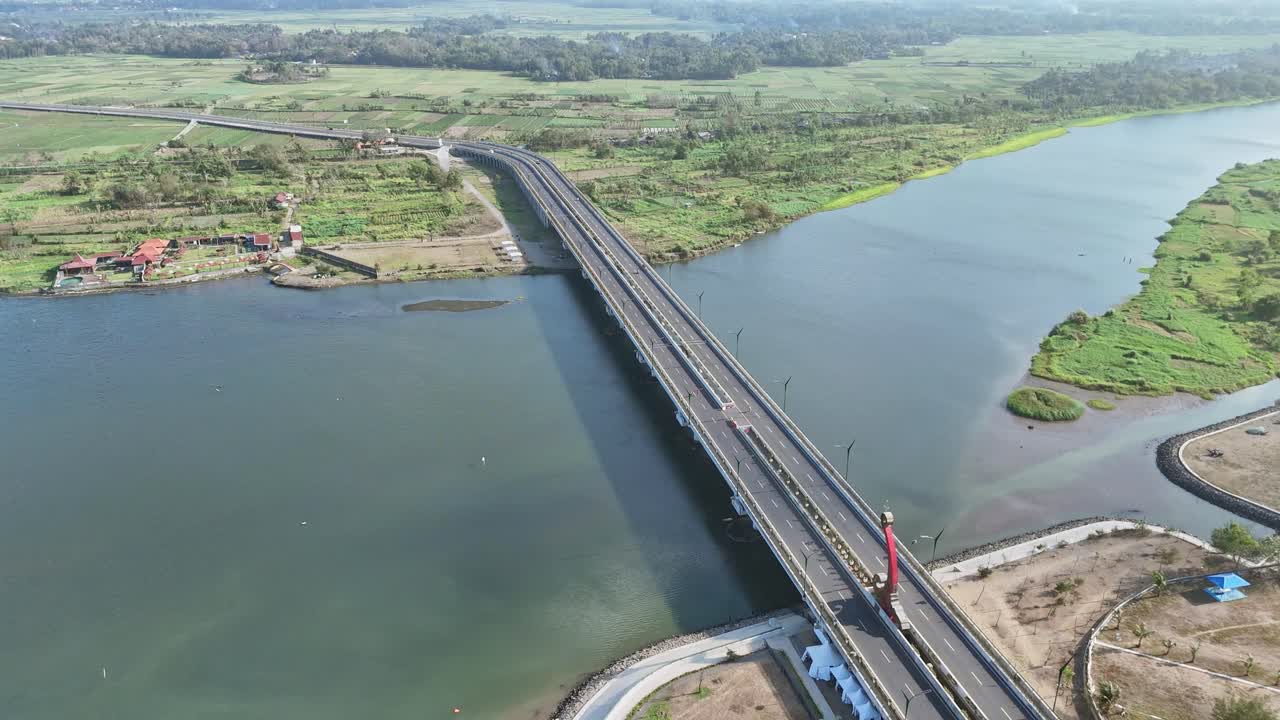 Scenic aerial view of big bridge on big river on rural indonesia. Bridge with green plantation on the background. Kretek II Bridge, Yogyakarta, Indonesia.