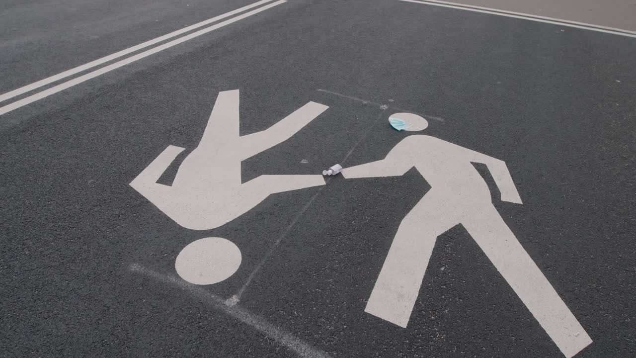Static Shot Of Painted Pedestrian Symbols On Road Surface With Surgical Mask And Hand Sanitizer, Central Park, New York City