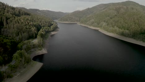 Scenic-Drone-Shot-of-a-beautiful-lake-at-sunset-in-the-Harz-National-Park,-Germany,-Europe