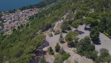 Flying-over-the-white-stone-cross-of-Split-and-panning-up-to-the-Adriatic-Sea