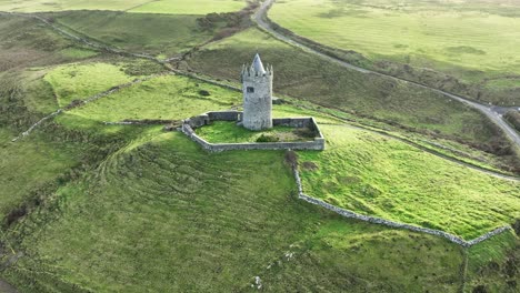 drone pulling away shot of doolin castle wild atlantic way in winter morning