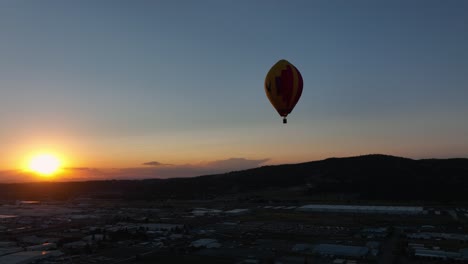 Plano-Amplio-De-Un-Globo-Aerostático-Volando-Por-El-Cielo-Dorado