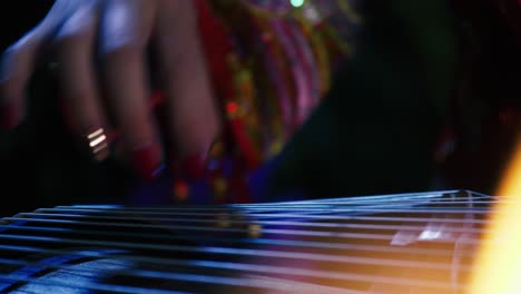 chinese girl playing guzheng indoor