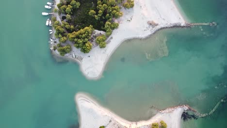 top down view rising from beautiful beach in greece at sunset aerial drone footage