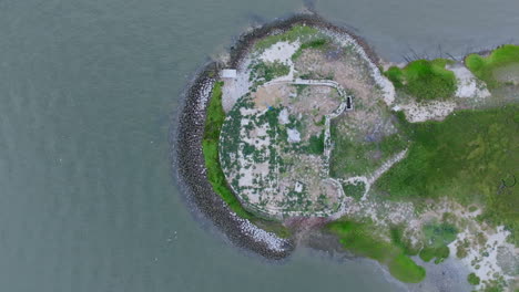 aerial drone view of historic island ruins with boat