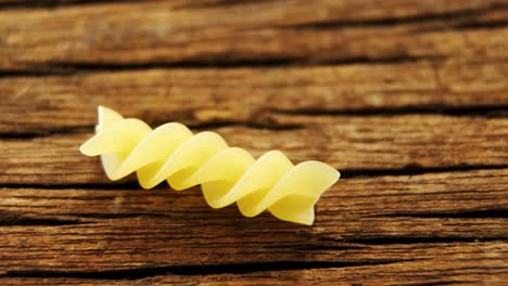 fusilli on wooden table