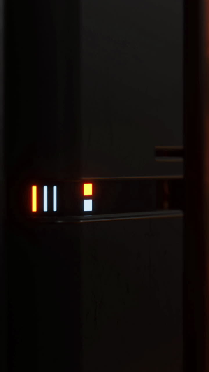 Glowing lights shine from sleek technology in a darkened space