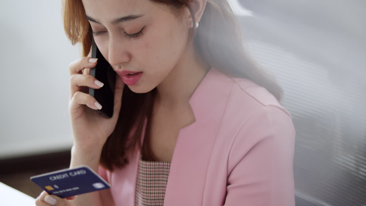 A woman manages her finances over a call demonstrating effective money handling.