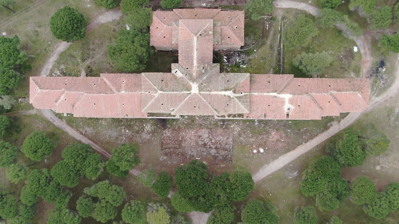 Large abandoned building in the midle of the pine forest (Viana de Cega Sanatorium, Valladolid) Aerial drone cenital footage