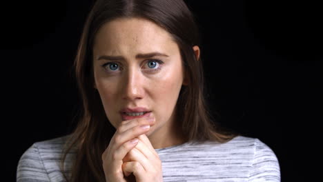 Studio-Shot-Of-Scared-Young-Woman-Looking-Into-Camera