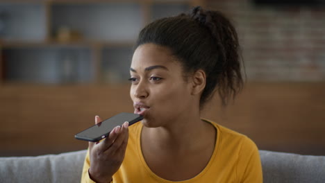 woman using a smartphone voice assistant