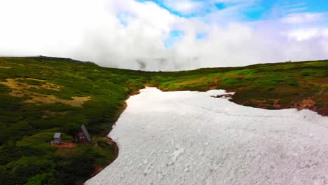 daisetsuzan national park drone flight, hiking on ice towards a shelter