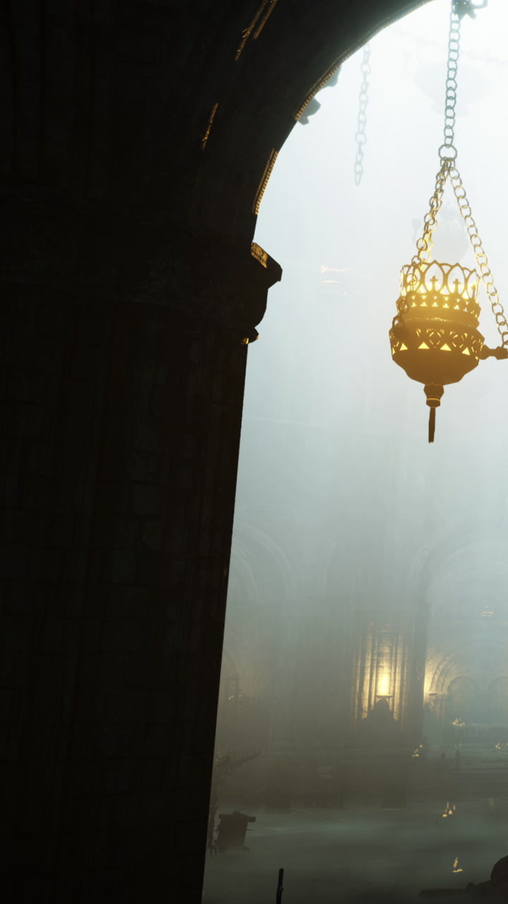 Light shines through a dimly lit space with a hanging lamp and shadows
