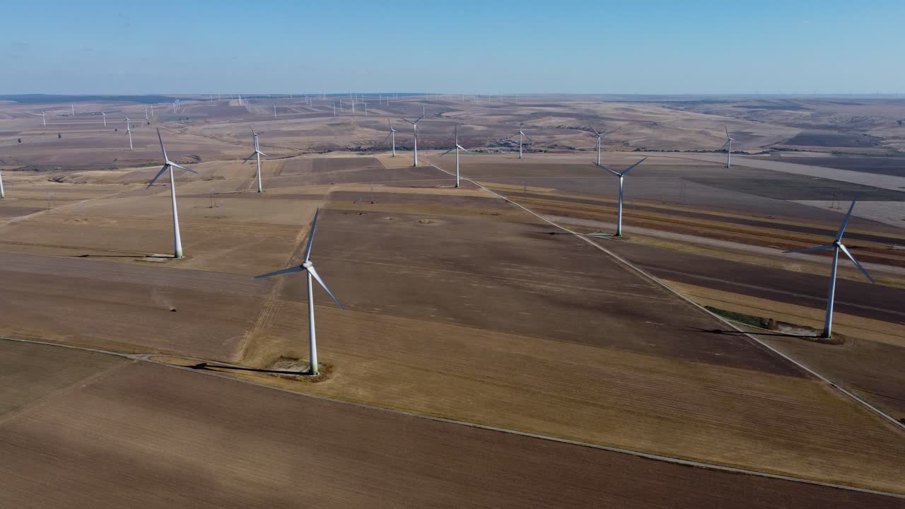 Wind turbines spread out over vast area on wind park, aerial shot