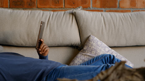 Senior man using digital tablet in living room 4k
