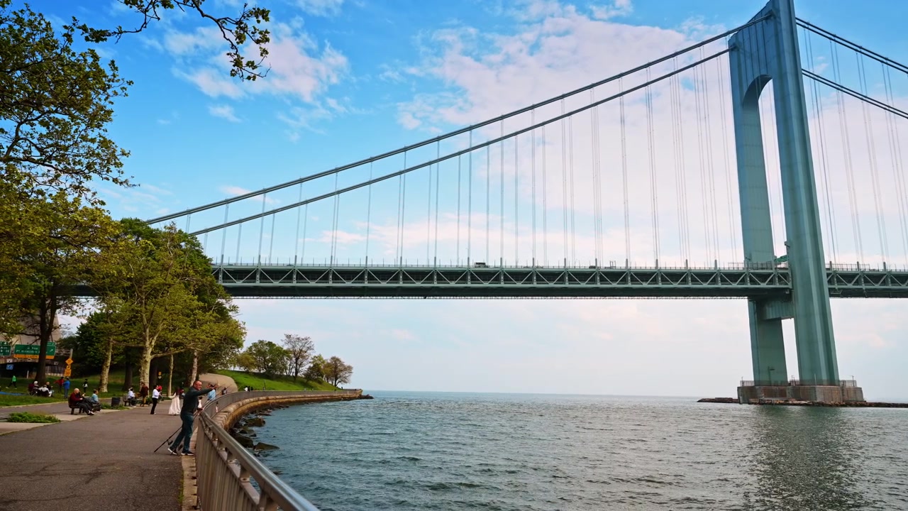 Nueva York, EE. UU., 1 de mayo de 2026: Puente Verrazzano-Narrows sobre el agua en Nueva York. Una alta torre de puente de acero se eleva desde el mar mientras la pasarela peatonal curva recorre la orilla verde