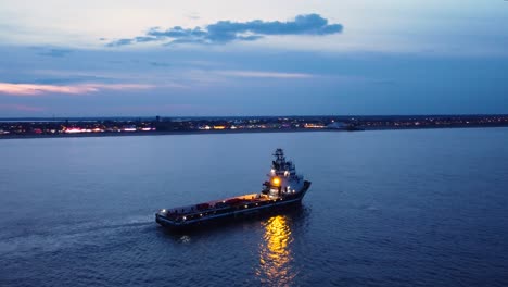 sailboat in sunset light taken from drone - aerial video of peaceful scene with yacht cruising at open ocean at dusk