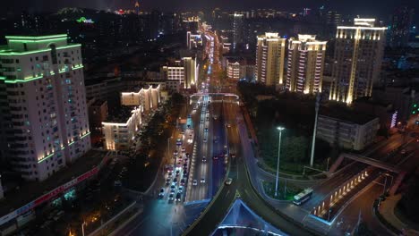 qingdao city night illumination busy traffic street aerial panorama 4k china