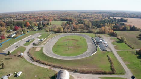 whittemore small track car racing speedway in whittmore , michigan with drone video moving forward