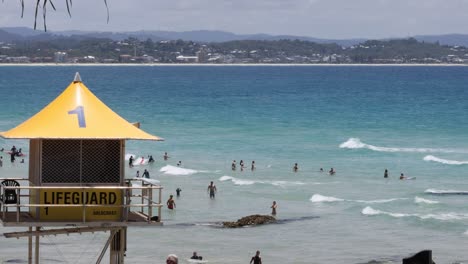 crowded beach scene with active lifeguard station