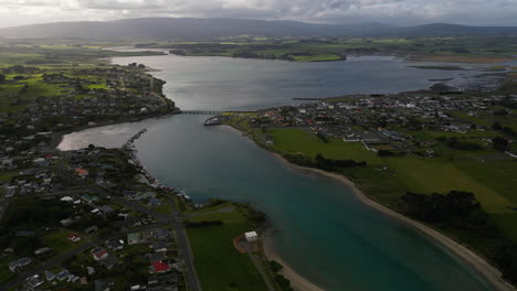 Aerial-shot-of-village-with-river-and-houses-during-the-morning-time