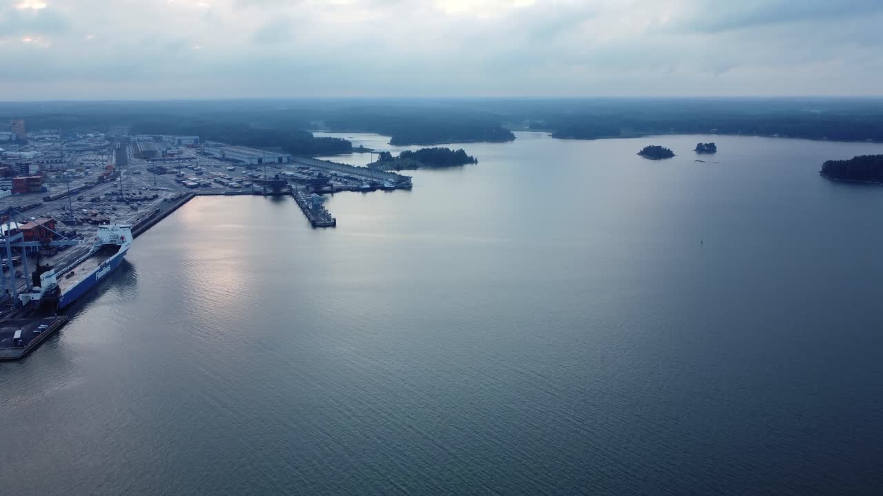 Aerial view of a harbor with a ship and a city in the background