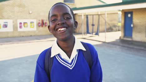 portrait of a young schoolboy smiling in playground 4k