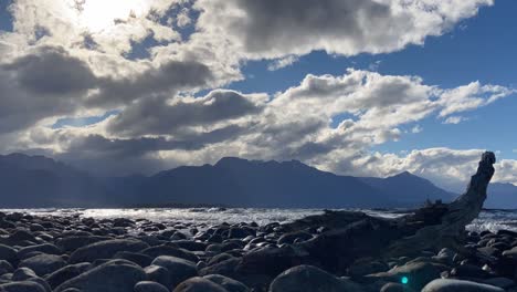 Clouds-rolling-in-the-blue-sky-over-the-calm-Te-Anau-Lake-in-New-Zealand--timelapse