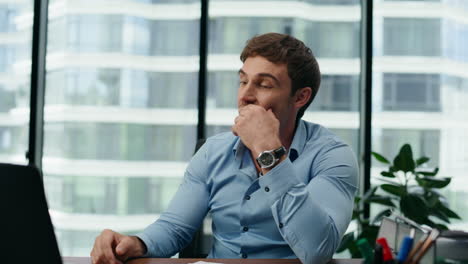 Smiling-man-communicating-online-conducting-video-conference-in-office-close-up.