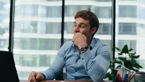 smiling man communicating online conducting video conference in office close up.