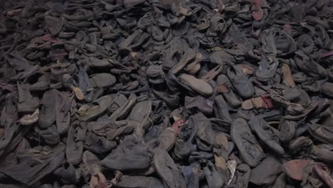 video of shoes pile with focus on angles and compositions a video displaying various shots of stacked shoes on a table and the ground highlighting different angles and compositions of the shoe pile