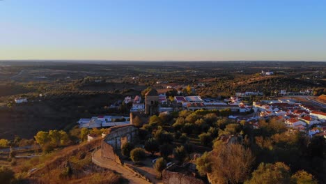 drone shot of a medieval tower on a hill in alentejo, portugal