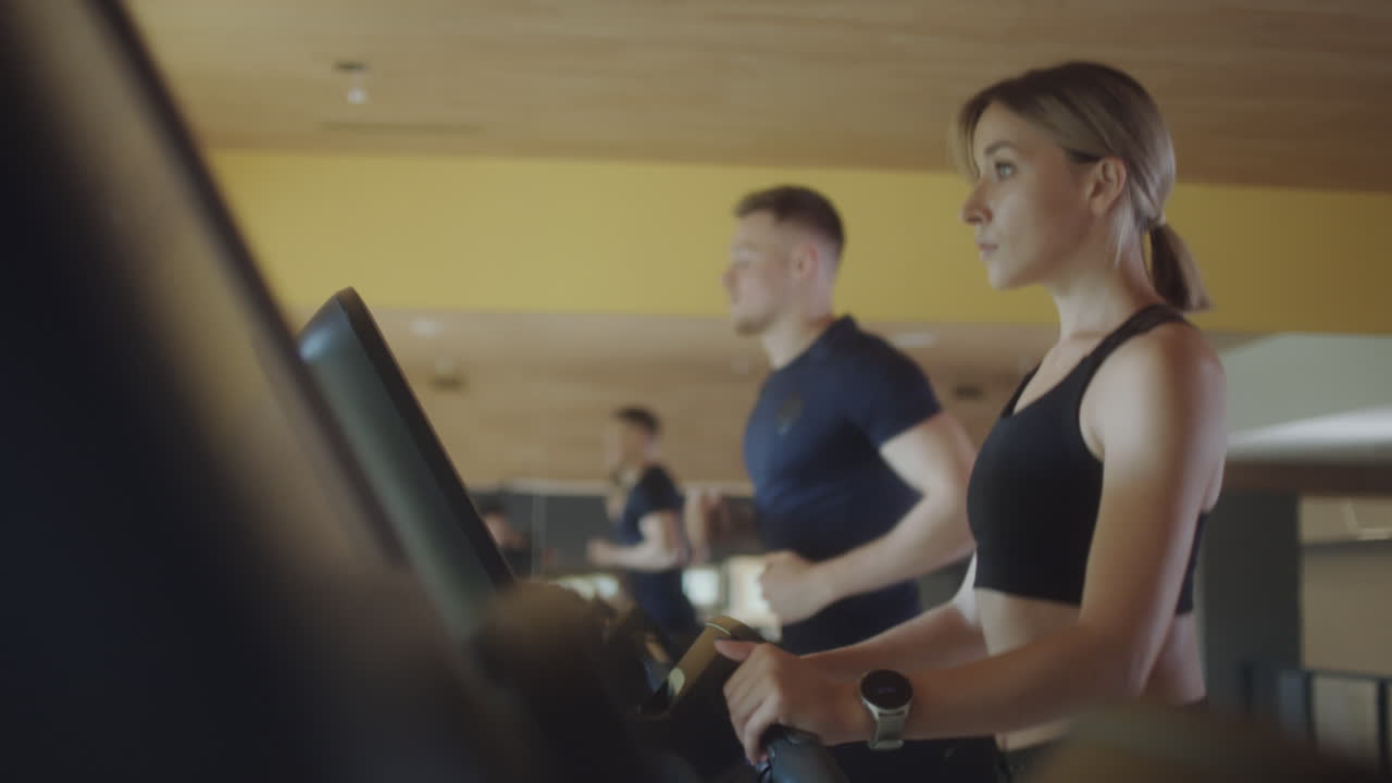 Woman Walking on Gym Treadmill