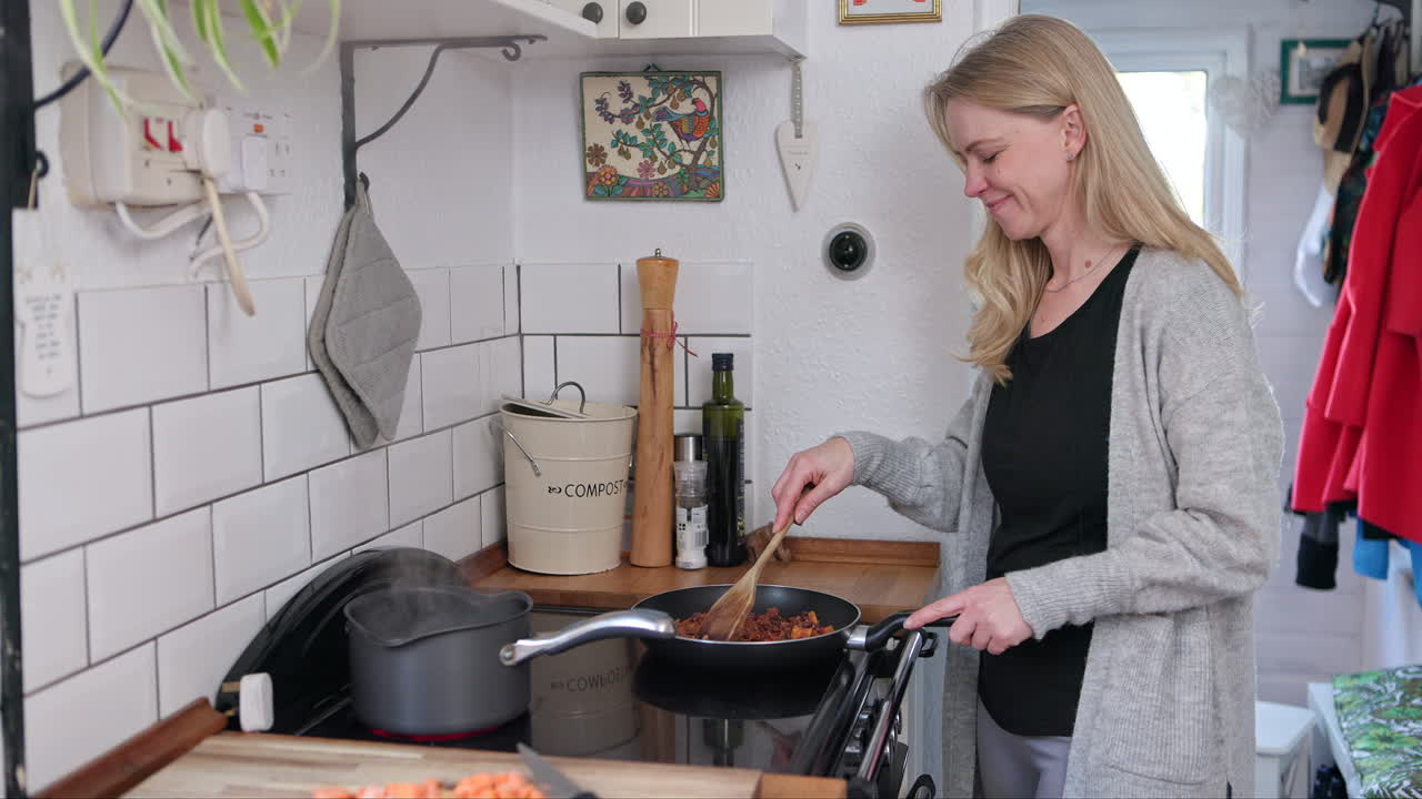 A woman cooking food in the kitchen