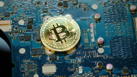 Bitcoin-mining-concept.-Gold-bit-coin-lie-on-circuit-board