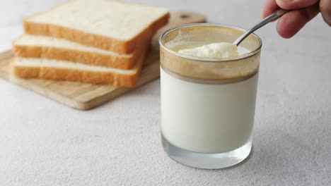 Glass-of-whole-cream-milk-on-table-,