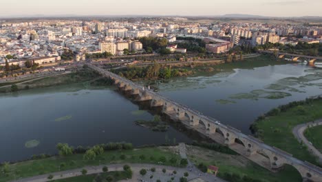 aerial view circling badajoz puente de palmas viaduct bridge crossing guadiana park river, spain