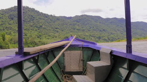 driving a boat on the amazon river in peru, south america