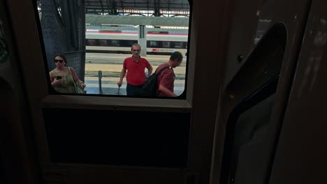 people waiting at a busy train station