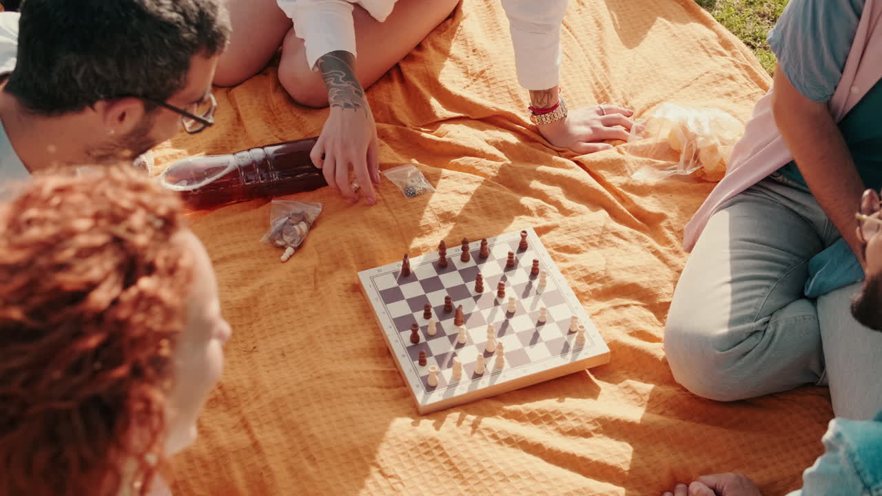 Friends Playing Chess at a Picnic