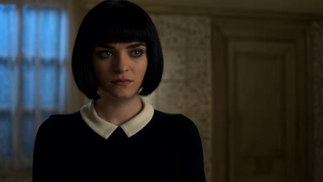 portrait of a young woman with black bob haircut and peter pan collar dress