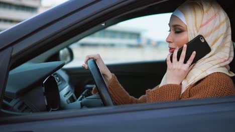 woman driving a car and talking on the phone