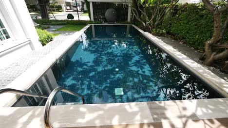 Close-Up-Footage-of-Blue-Tiles-Swimming-Pool-in-the-Garden