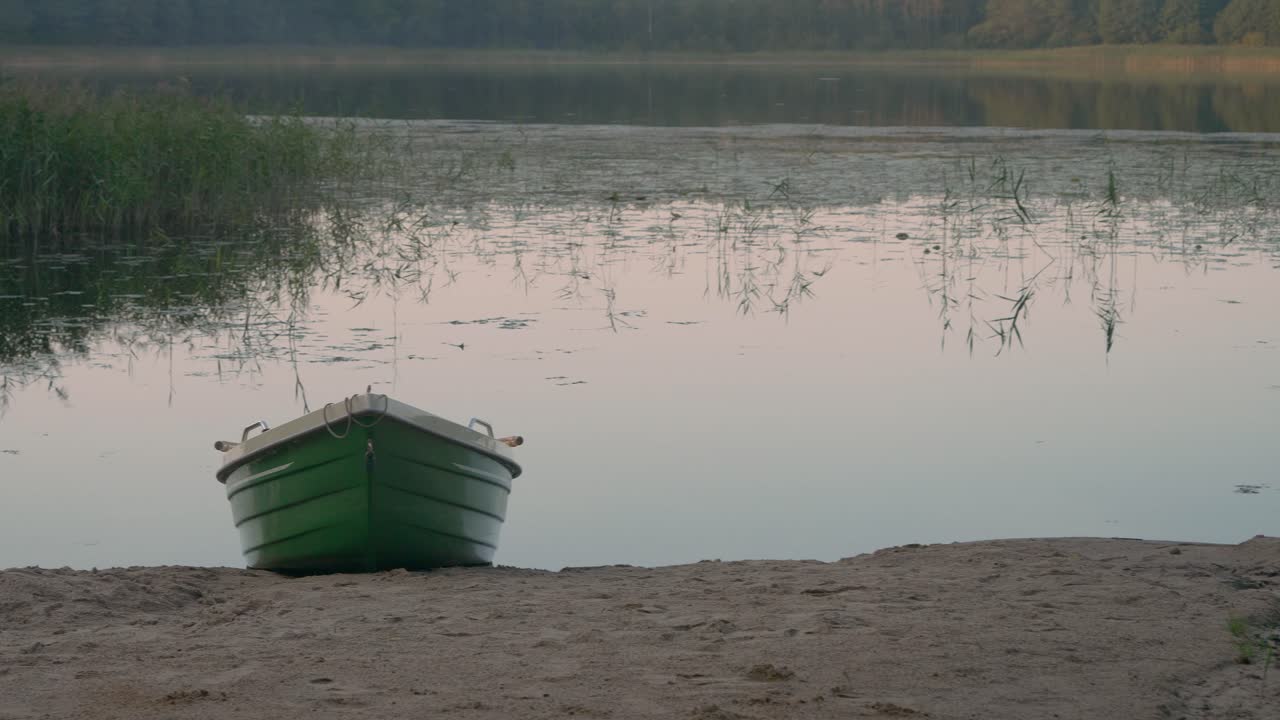 Serene Green Boat on a Calm Lake at Sunset