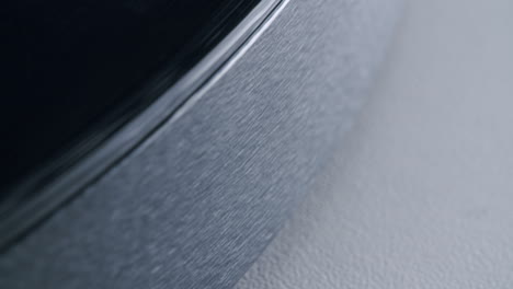close up shot of the side of a turntable with a spinning record. abstract graphic shot with shallow depth of field