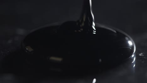 oil being poured onto black surface